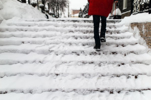 51309699 - woman climbs the stairs in the snow