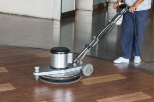 57109192 - woman worker cleaning the floor with polishing machine